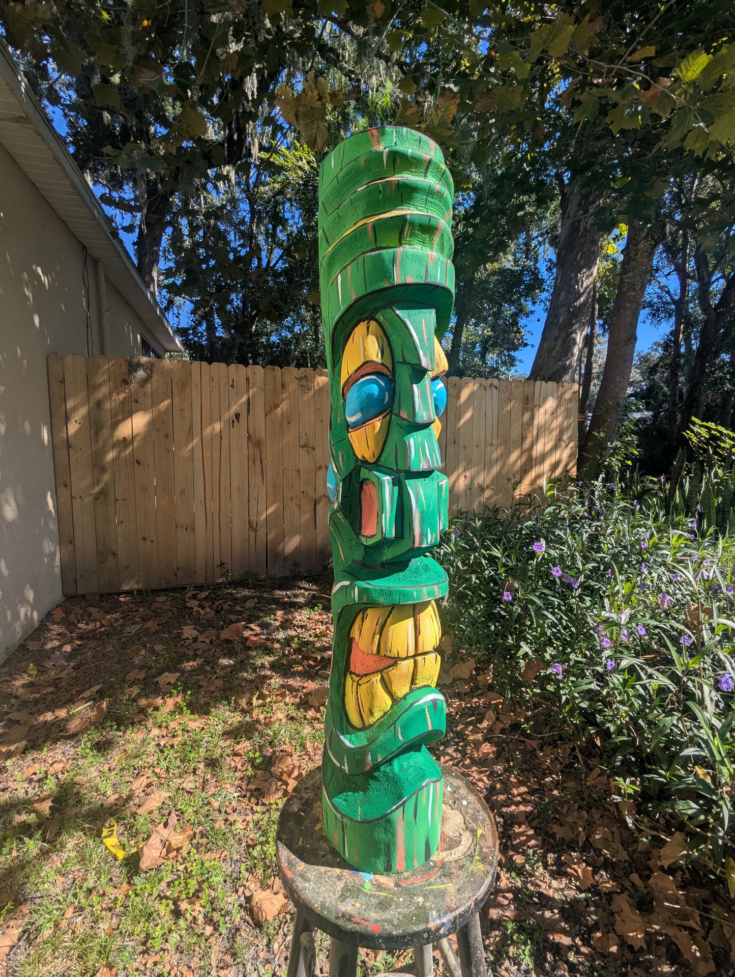 Green painted tiki.