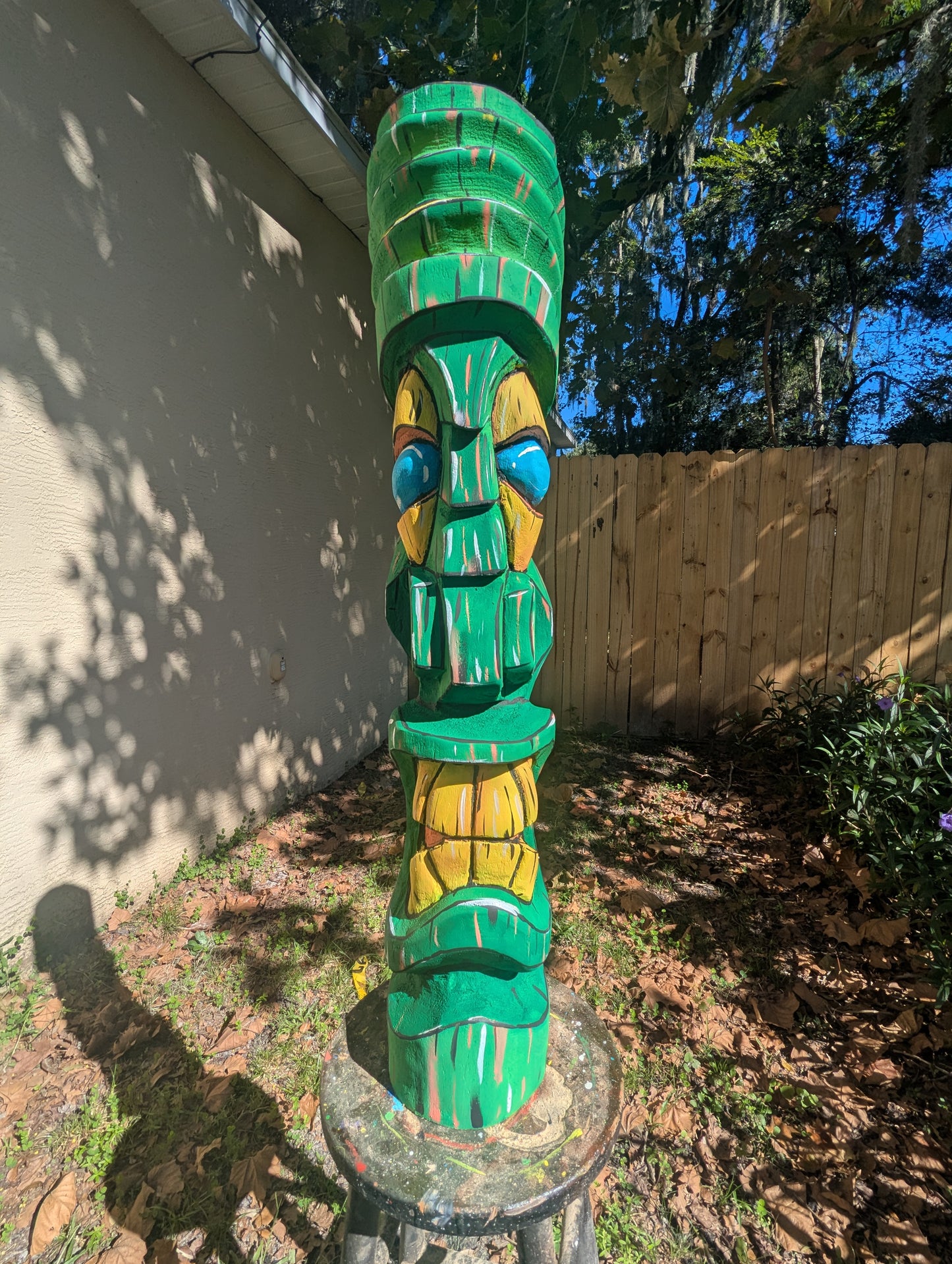 Green painted tiki.