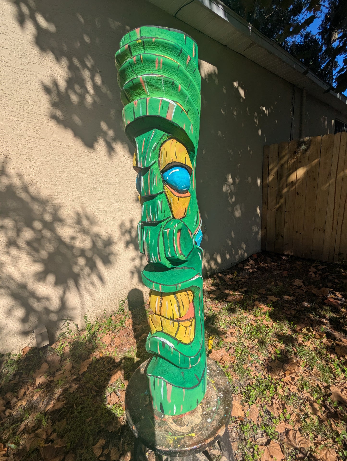 Green painted tiki.